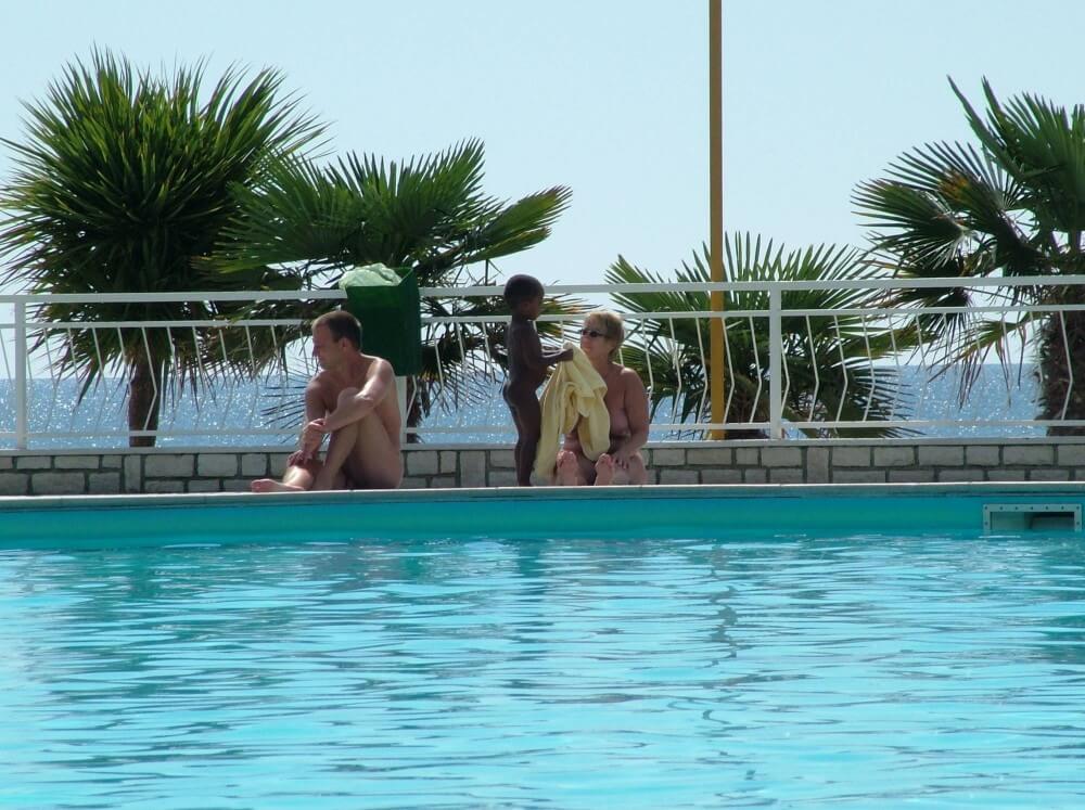 Photo of naturists in an outdoor pool - The practice of naturism is a path to inner harmony and peace